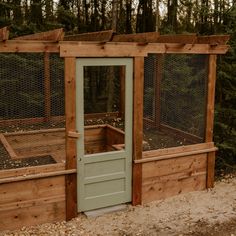 a chicken coop built into the side of a wooded area