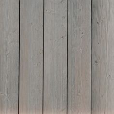 a red stop sign sitting on the side of a wooden fence