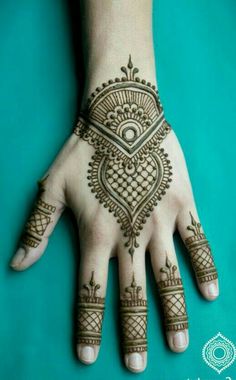 the hand is decorated with henna designs