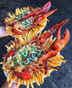 two plates filled with pasta and lobsters next to each other