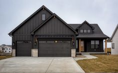 a large house with two garages in the front and one on the other side