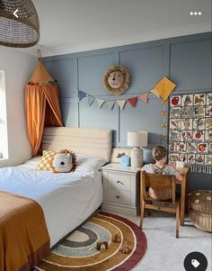 a child's bedroom with blue walls and orange accents