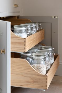 two wooden drawers with glass jars in them