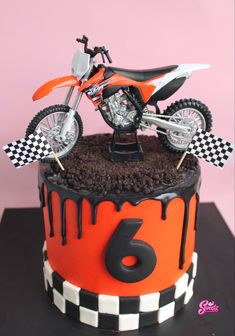 a birthday cake with a dirt bike on top