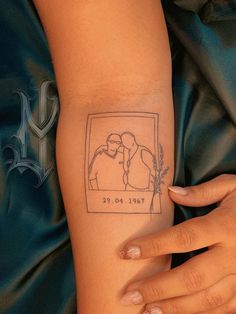 a woman's arm with a drawing of two people on the left side of her