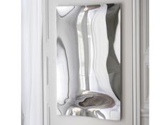 an open door with a mirror reflecting the reflection of white objects on it's side