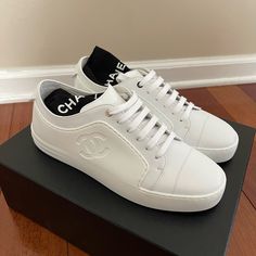 Brand New In Box, 100% Authentic Chanel Leather And Rubber Low Top Tennis Sneakers/Trainers G32719, In White, Women’s Eu Size 38 (Fits A U.S. 7-8). In Giftable Condition. Comes With Complete Original Packaging. Never Worn. Chanel Sneakers White, Luxury Slip-on Sneakers With Perforated Toe Box, Designer Calf Leather Slip-on Sneakers, Luxury Calf Leather Slip-on Sneakers, Chanel Tennis Shoes, Chanel Trainers, Lux Life, Rubber Sneakers, Chanel Sneakers