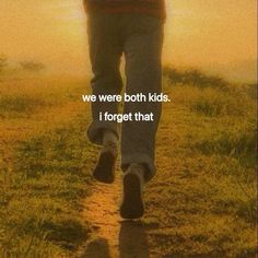 a person walking down a path with the words, we were both kids i forget that