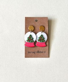 a pair of earrings with a christmas tree on it