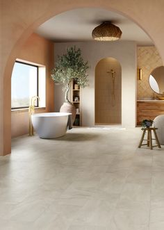 a large bathroom with an arched doorway leading to the bathtub and sink area, along with a round mirror on the wall