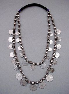 A two strand necklace from North India.The die-stamped pod-shaped beads have small wooden buffer beads in between to protect them from rubbing against each other. | Silver and wood | German Silver Jewelry, Diy Collier, North India, Boho Accessories, India Jewelry, Hippie Chic, Strand Necklace