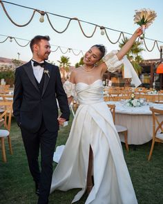 a bride and groom holding hands while walking down the aisle at their wedding reception in palm springs, florida