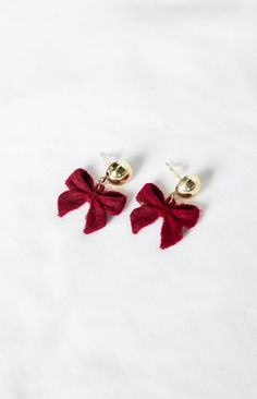 Gold & Red Velvet Bow Earrings

How to style:
Add a subtle pop of colour to your look with our Isibel Red Bow Earrings! Featuring an adorable bow charm made in a stunning deep red velvet material, these earrings are the perfect final touch to any outfit. Pair with a classic LBD () for date night and finish with a matching coloured bag () to tie the whole look together! 

Features:


  
 * Deep red velvet bow 
 
 * Gold hardware
 
 * Push back closure
 
 * Hanging design Burberry Earrings Bow, Deep Red Velvet, Hanging Design, Red Accessories, Beginning Boutique, Bow Earrings, Velvet Bow, Velvet Material, Final Touch