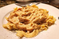 a white plate topped with pasta and sauce