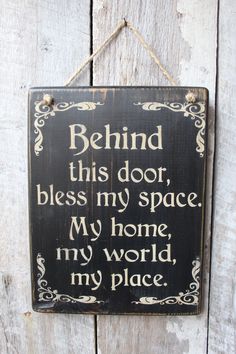 a sign that says behind this door, blessing my space is my home, my world, my place