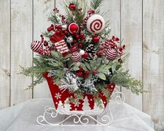 a red and white christmas centerpiece with candy canes