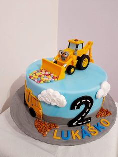 a birthday cake for a two year old boy with a construction truck on top and the number 2