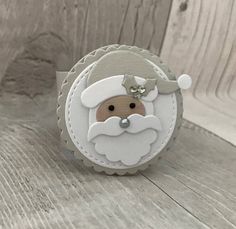 a close up of a small christmas ornament on a wooden surface