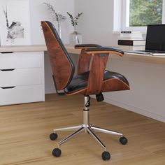 an office chair sitting on top of a hard wood floor next to a desk with a laptop computer