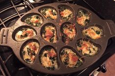 a pan filled with muffins sitting on top of an open stove burner