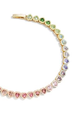 Add a dash of romance to your wrist with this whimsical tennis bracelet hosting a rainbow gradient of crystals in dainty heart settings. 7" length; 1/8" width Goldtone plate/glass Imported