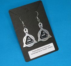 STK303 Welcome! After many requests, we are happy to present another of our Therian creations, one pair of earrings with the Theta-Delta symbol. This listing is for a highly detailed, set of Therian Symbol Earrings that was handmade and cast by my Husband and I, in our studio in Michigan, USA. These are made with silver pewter, and is 100% lead-free! They measure 1 3/16" (30mm) tall by approximately 1" wide (25.8mm) wide, not including the 925 Sterling Silver French Wire earring hooks.  There ar Therian Symbol, Delta Symbol, Pride Symbol, Matching Pendants, Symbol Earrings, Pride Earrings, Pride Necklace, Pewter Jewelry, Wire Earring