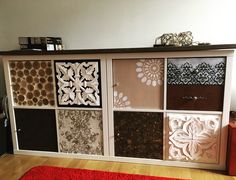 an area rug is placed on the floor in front of a cabinet with decorative panels