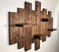 a wooden wall mounted shelf with shelves on it