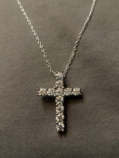 "A 3.20 total carat moissanite diamond with a cross design made on sterling silver, the diamond is lab created at a VVS1. comes with a necklace made of sterling silver at 18\"long" Silver Diamond Cross Pendant Jewelry, Diamond White Cubic Zirconia Cross Pendant Necklace, Diamond White Cross Pendant Necklace In Cubic Zirconia, Silver Cross Jewelry With Brilliant Cut, Silver Brilliant Cut Cross Pendant Jewelry, Formal Sterling Silver Pendant Cross Necklace, Formal Cross Pendant Diamond Necklace In Cubic Zirconia, Elegant Sterling Silver Brilliant Cut Cross Necklace, Elegant Brilliant Cut Sterling Silver Cross Necklace