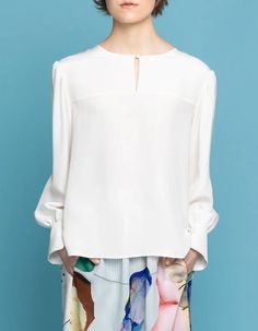 This silk crepe blouse with our signature puff sleeves and front key-hole detail is a must have in your wardrobe. It's an exclusive feminine staple pieces which you easily combine with all your skirts and trousers already hanging in your wardrobe. It's our most versatile piece and you can literally wear it during all occasions. This piece is crafted with love for detail and has fabric covered button closure in front as well on the puff sleeve cuffs. The back is longer than the front and the heml