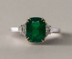 Elianna 3.95 Carats Cushion Cut Emerald Gemstone Ring in 18K White Gold By Mike Nekta NYC Certified Center Emerald Gemstone:Diamond Weight: 0.43 CaratGemstone Weight: 3.95 CaratsDiamond Color: Diamond Clarity: VSStyle: Cushion CutSpecies: EmeraldGemstone Color: GreenOrigin: ZambiaMeasurement: 1.19 x 8.8Metal:Gold Weight: 6.184 gramsGross Weight: 7.06 gramsSetting: Three StoneMetal: 18k White GoldSize: 7 Total Carat Weight: 4.38 Carats Luxury Three Stone Gemstones For Anniversary, Luxury Emerald Ring With Cushion Cut Center Stone, Luxury Cushion Cut Emerald Ring With Center Stone, Luxury Cushion Cut Gemstones For Wedding, Luxury Emerald Three Stone Ring For Formal Occasions, Luxury Three Stone Emerald Ring For Formal Occasions, Luxury Three Stone Emerald Ring For Formal Events, Classic Cushion Cut Gemstone For Anniversary, Luxury Cushion Cut Emerald Ring