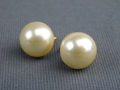 "This is a great pair of vintage signed Crown Trifari clip on earrings with off white dome shaped faux pearls. They are in excellent vintage preowned condition and are 1/2\" diameter. See our other listings for more great vintage designer jewelry. All measurements are approximate. Please refer to the photos as they are an integral part of the description. Be sure to contact me with questions prior to purchasing. Due to differences in screen settings, colors may differ slightly between photos and Formal Cream Pearl Earrings, Classic Clip-on Earrings For Vintage Events, Classic Clip-on Earrings For Wedding, Classic Wedding Clip-on Earrings, Vintage White Clip-on Earrings For Wedding, Vintage Designer Jewelry, Crown Trifari, Pretty Earrings, Classic Wedding