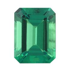 an emerald colored stone on a white background