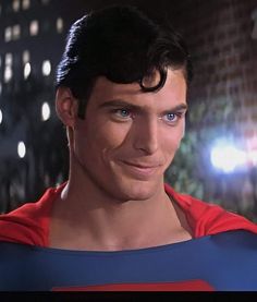 a close up of a person wearing a superman costume