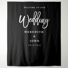 the welcome banner is hanging on the wall in front of a white and black backdrop