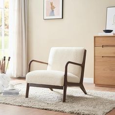 a chair sitting on top of a rug in a living room next to a window