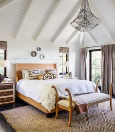 a bedroom with white walls and wooden furniture