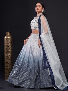 Indulge in the luxury and elegance of our shade of navy-blue and white lehenga choli with a coordinated waist belt. This exquisite lehenga choli set is designed to captivate and leave a lasting impression.
The lehenga itself boasts a stunning combination of navy-blue and white, adorned with dazzling sequins work that is sure to make heads turn. The intricate sequins work adds a touch of glamour and sparkle to the ensemble, elevating it to new heights of beauty. The lehenga features a flattering Formal White Floor-length Lehenga, Blue Lehenga For Formal Party Wear, Blue Party Wear Lehenga For Formal Occasions, Blue Formal Party Wear Lehenga, Blue Lehenga For Diwali Formal Occasion, Formal White Semi-stitched Lehenga, Formal Bollywood White Lehenga, White Lehenga Choli, Bridesmaid Lehenga