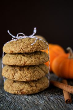 a stack of cookies sitting next to an orange pumpkin