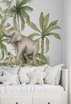 an elephant and monkey mural on the wall in a child's bedroom with white bedding