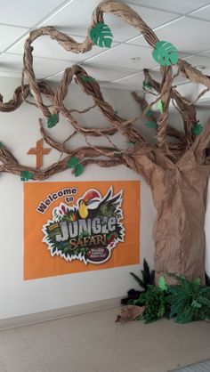 an office decorated with paper mache and fake tree branches for the jungle safari theme