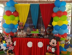 a mickey mouse themed birthday party with balloons