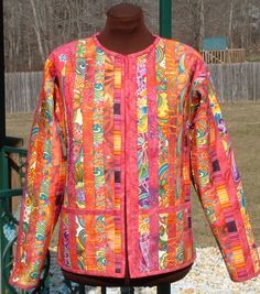 an orange jacket with colorful designs on it