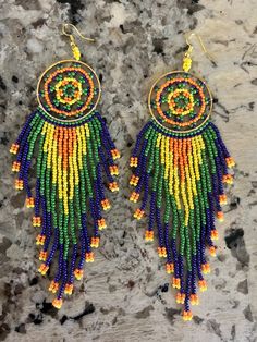 This lovely pair of beaded earrings scream vacation! These bold colors and vibrant hues make statement with any outfit or swimwear! they can be worn day or night and make a perfect addition to your jewelry collection! Multicolor Hoop Earrings For Summer Festival, Multicolor Summer Festival Hoop Earrings, Vibrant Rainbow Dangle Earrings, Fun Beaded Dangle Earrings For Beach, Yellow Beaded Earrings For Summer Beach, Fun Beaded Earrings For The Beach, Beaded Dangle Chandelier Earrings For Beach, Fun Beaded Earrings For Beach, Fun Beaded Earrings For Beach In Summer