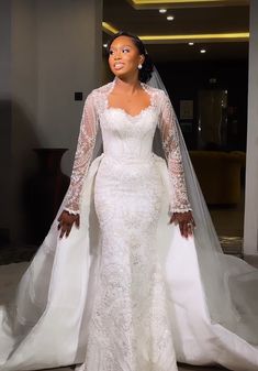 a woman in a white wedding dress and veil