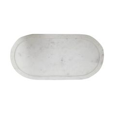 an oval marble tray with white paint on it