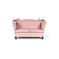 a pink couch sitting on top of a white floor