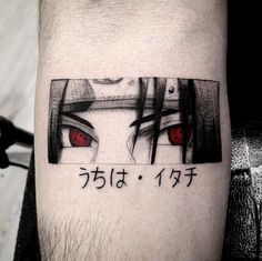 a man's leg with an anime tattoo on it and the words in japanese characters