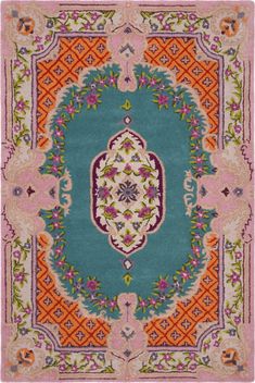 a colorful rug with an ornate design on the front and back side, in pink, blue