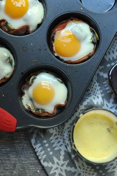 some eggs are in a muffin tin with orange juice